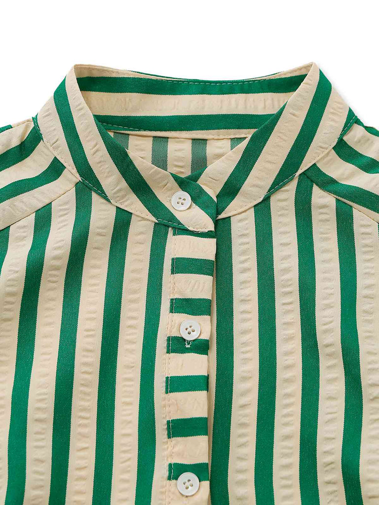 Nahaufnahme eines grün-beigen gestreiften Hemdes mit Knöpfen auf weißem Hintergrund