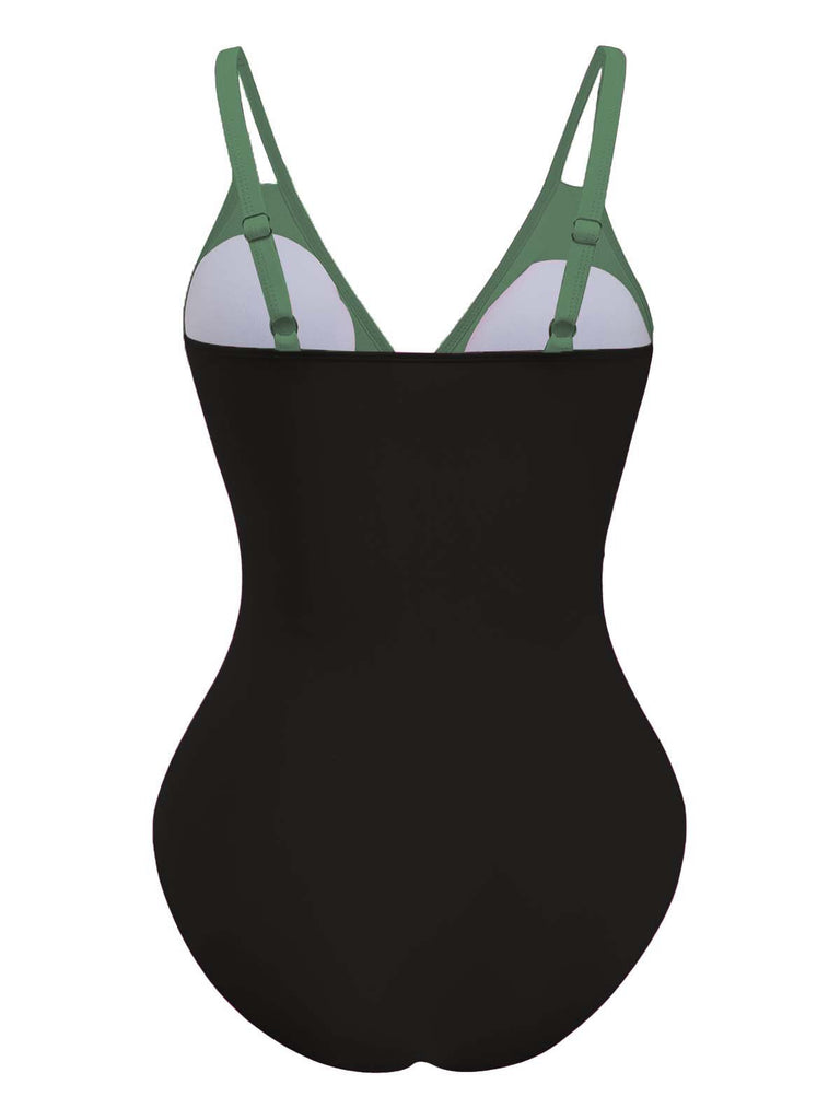 Schwarzer Badeanzug mit grünen Trägern auf weißem Hintergrund