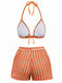 Orangefarbenes und weißes Bikini-Set auf weißem Hintergrund