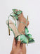 Grüne Sandalen mit Knöchelriemen und Schmetterling