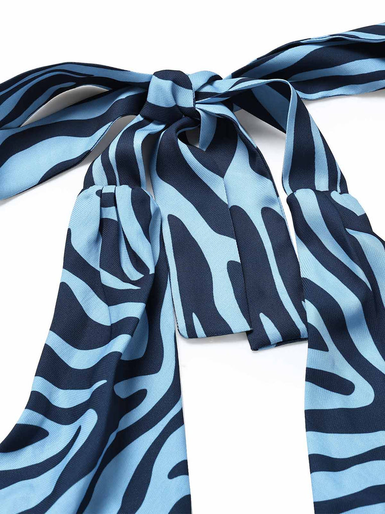 Seeblauer 70er Jumpsuit mit Zebra-Print und Neckholder