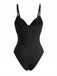Studioaufnahme von hinten, die den schwarzen Badeanzug mit seinem schlichten, eleganten Rückendesign und den verstellbaren Trägern zeigt.