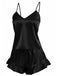 Das zweiteilige Set aus seidigem Satin-Top und Shorts ist in klassischem Schwarz mit femininen Rüschendetails abgebildet.