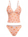 Retro-Tankini in Orange mit tiefem V-Ausschnitt und verspieltem Blumenmuster im 70er-Jahre-Stil, ideal für Sommerurlaube und Poolpartys im Vintage-Stil.